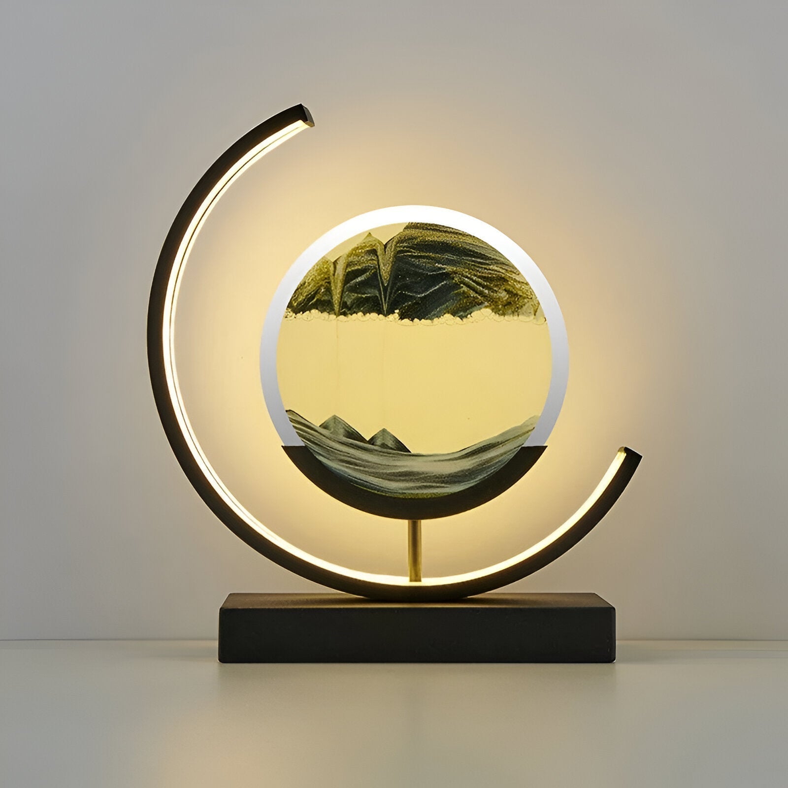 Illuminated youj black LED sand art light highlighting the detailed green falling sand