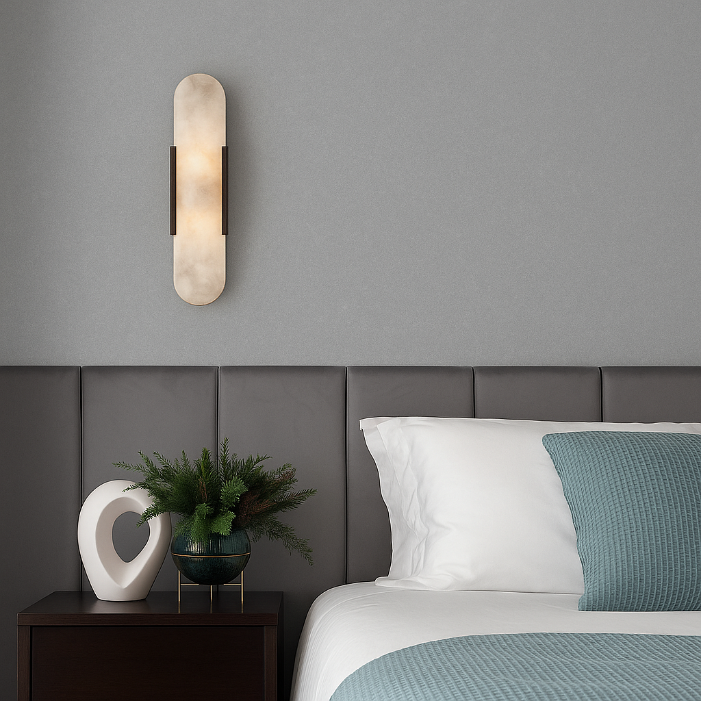 Black dolomite marble yuhy wall sconce providing warm ambient light in a moody, dark-toned bedroom