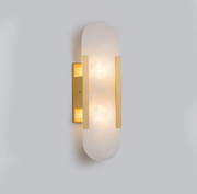 Modern yuhy gold dolomite marble pill-shaped wall sconce casting a warm, ambient glow