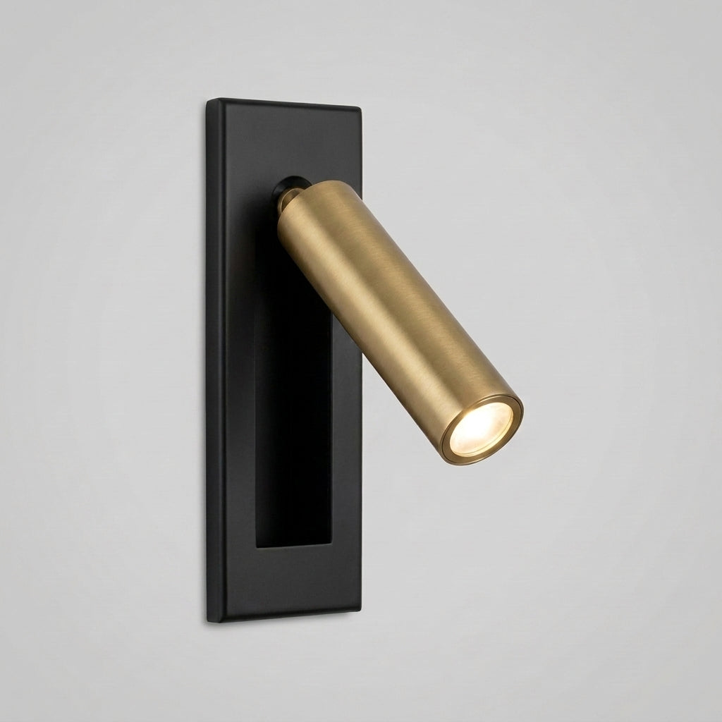 Zexto wall sconce in black and gold finish, illuminated, alternate angle on a grey studio background