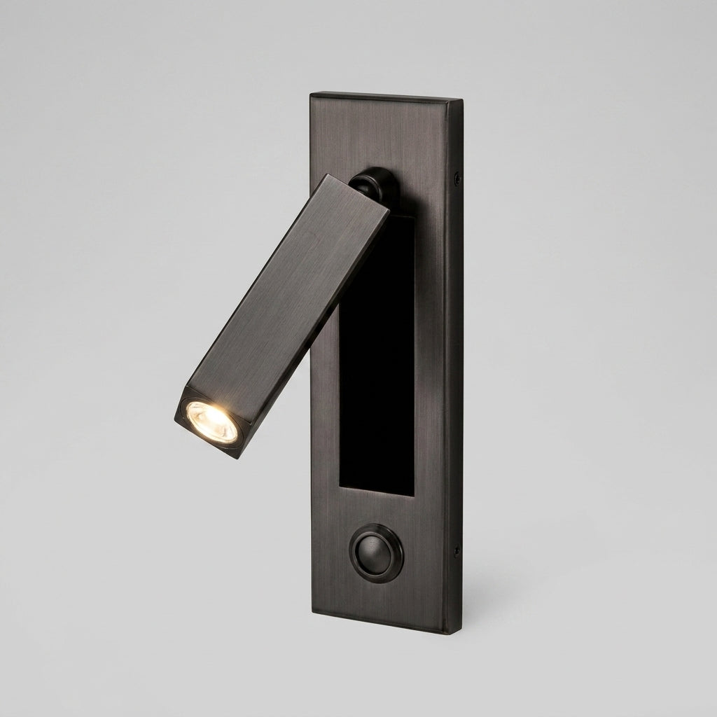 Zexto wall sconce in black finish showing the button switch, on a grey studio background