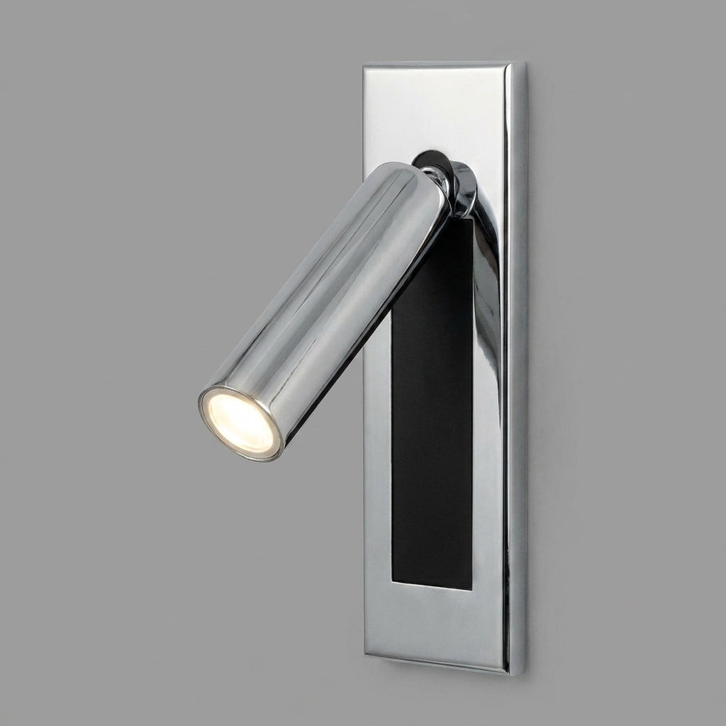 Zexto wall sconce in chrome finish, illuminated, on a grey studio background