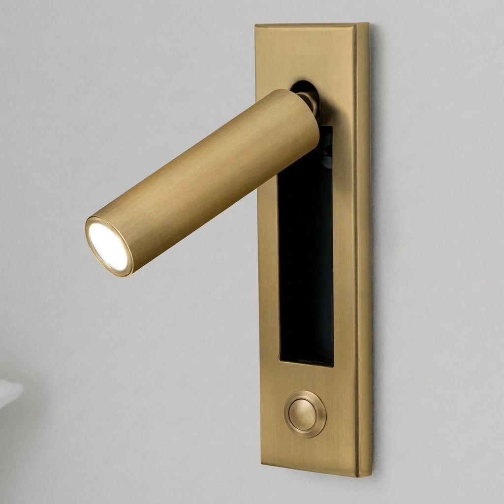 Zexto wall sconce in gold finish with button, illuminated, alternate angle on a grey studio background