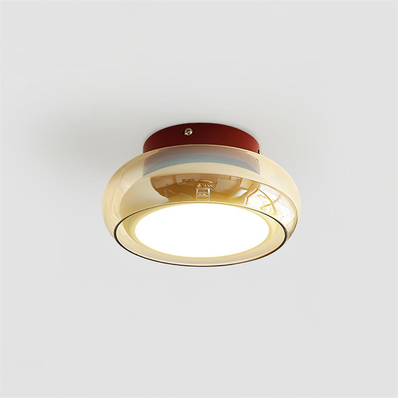 Modern retro flush mount zuba ceiling light featuring a red metal base and an amber tinted glass shade