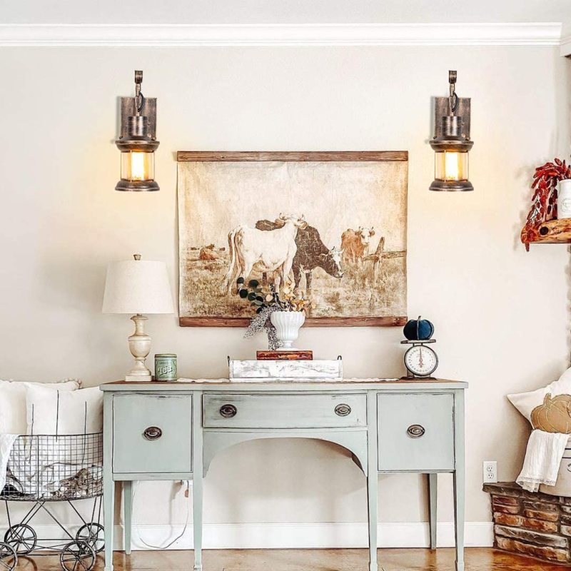 Two bronze zupce retro wall lamps installed above a vintage sideboard providing elegant ambient lighting
