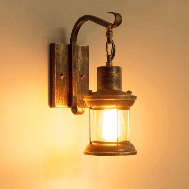 Close-up of the zupce illuminated bronze industrial lantern sconce casting a warm, nostalgic glow