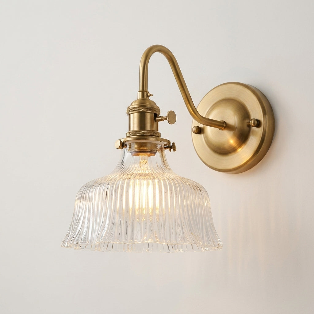 Zuvqa wall sconce with clear fluted glass shade, illuminated, hero product shot