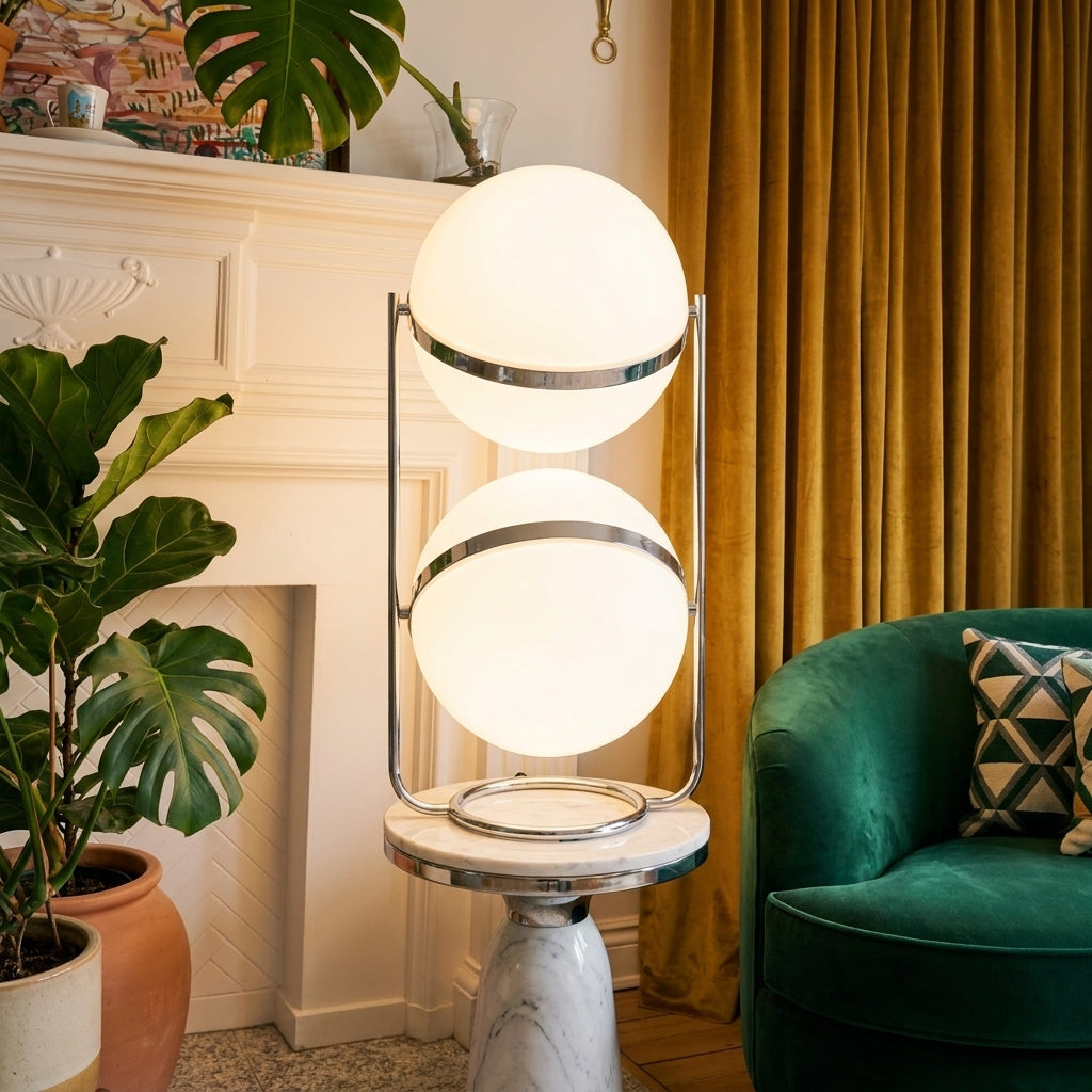 Zylpa Duo stacked chrome sphere floor lamp beside a fireplace and green velvet chair with gold curtains