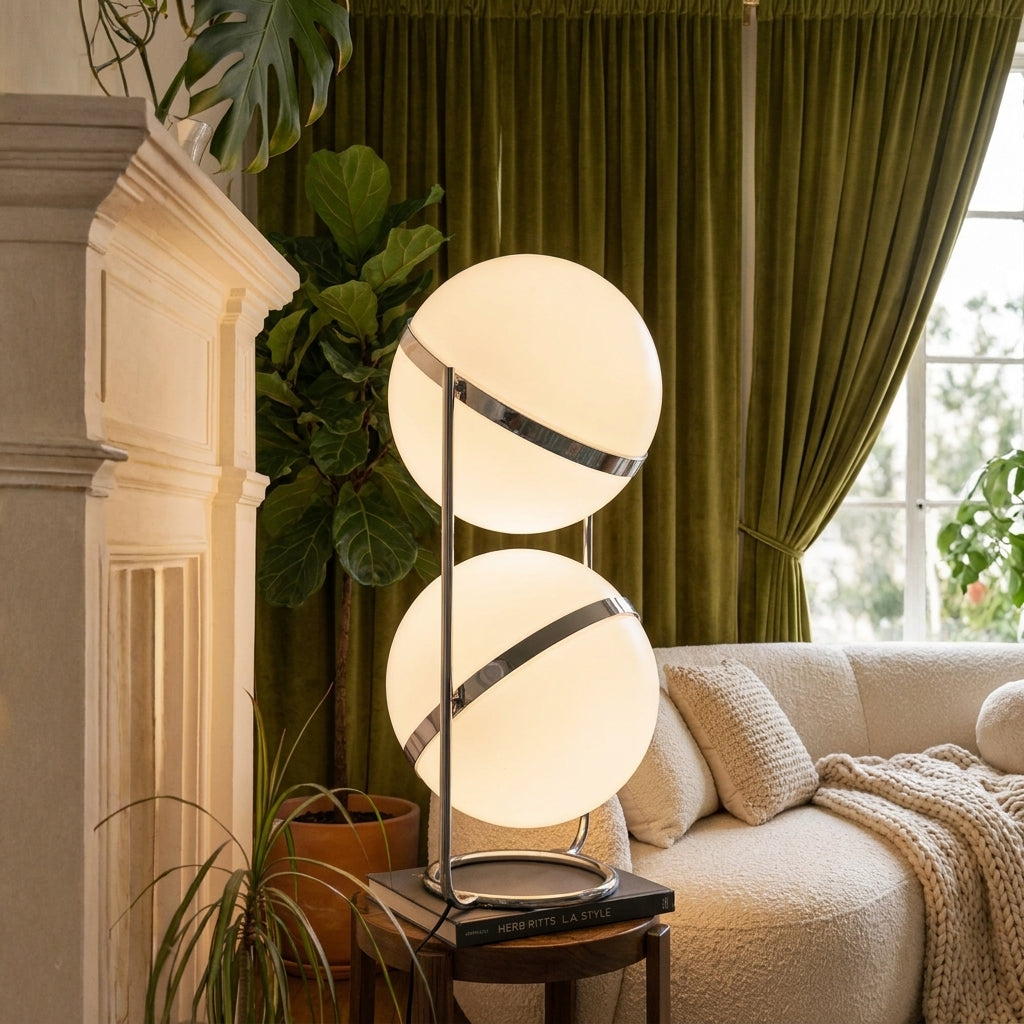 Zylpa Duo stacked chrome sphere floor lamp beside a fireplace with olive green curtains