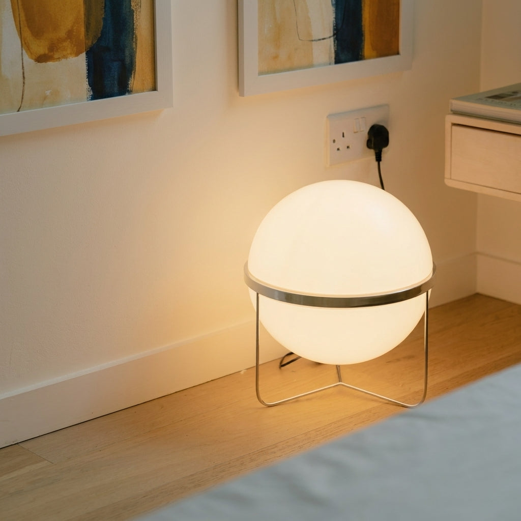 Zylpa Solo chrome sphere floor lamp in a bedside corner